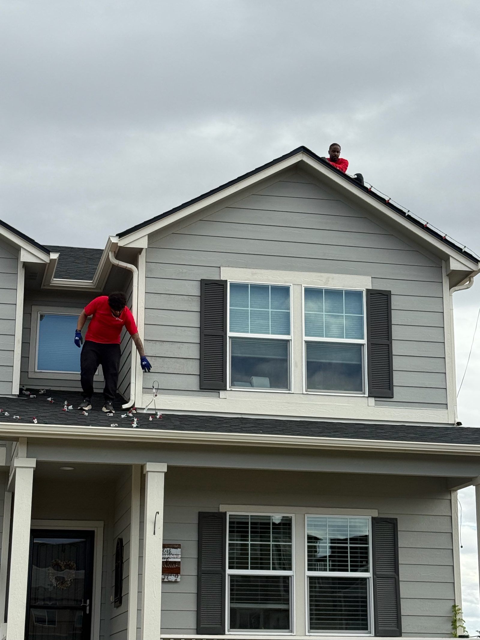Professional Christmas light installation crew on roof installing LED lights in Colorado Springs Professional Christmas light installation crew on roof installing LED lights in Colorado Springs